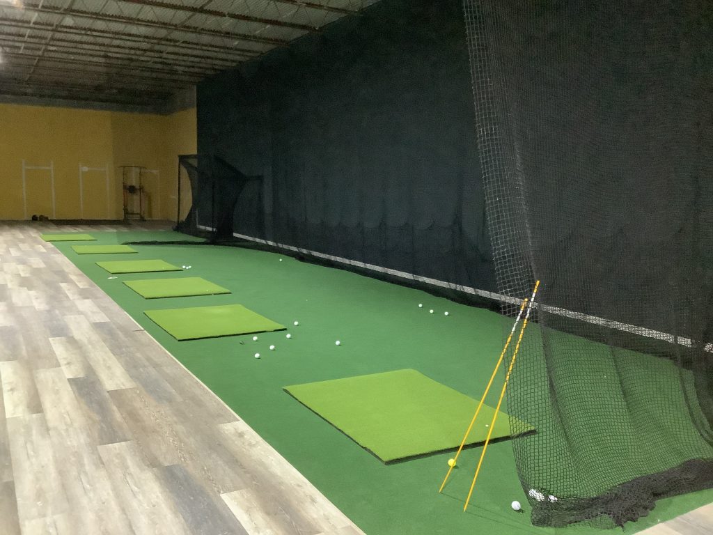 Hitting mats along a netted practice range inside Mashie Golf Institute in Myrtle Beach