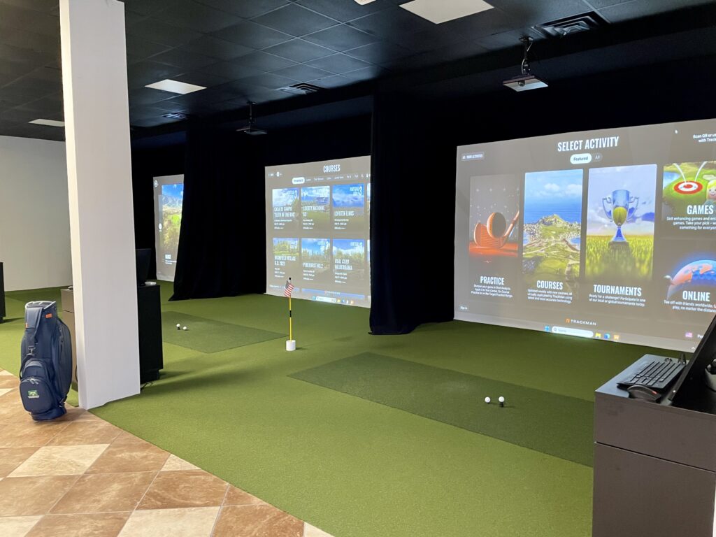 Three simulator screens and hitting mats inside Performance Indoor Golf in Pawleys Island, South Carolina