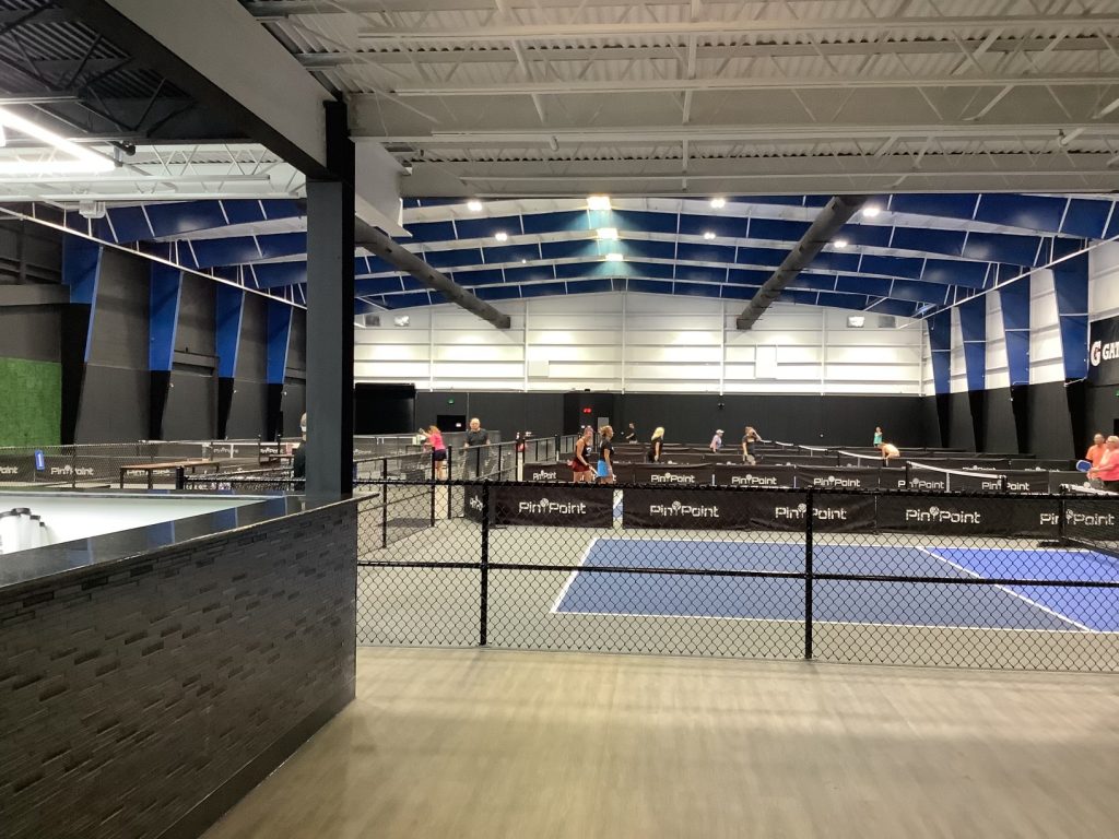 Pickleball courts and the main floor inside Pin Point Indoor Pickleball and Golf in Little River, South Carolina