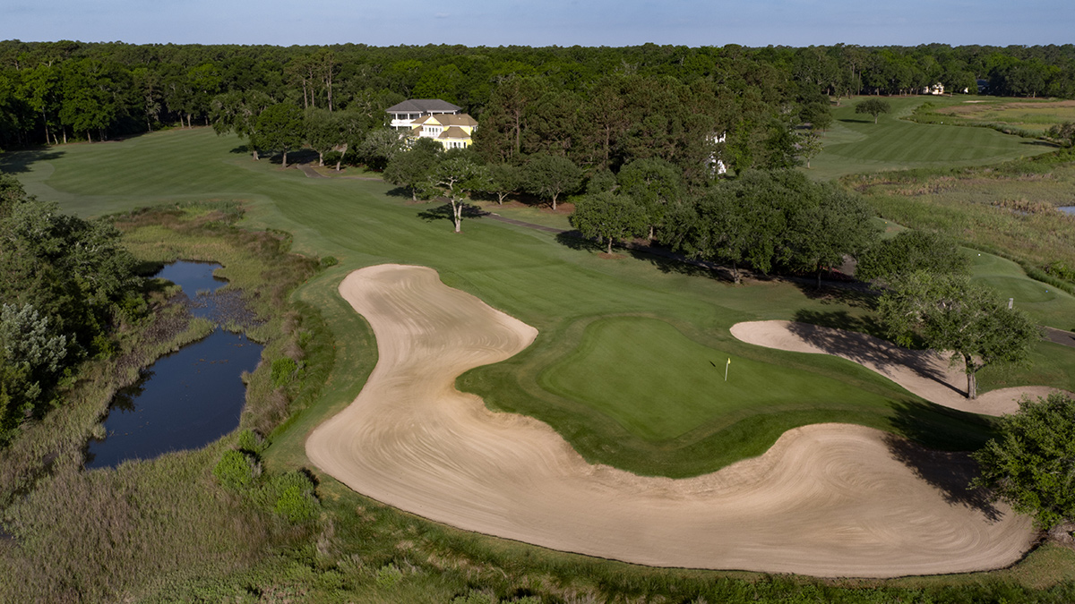 A green at Pawleys Plantation almost completely encircled by a huge waste bunker, with a pond and marsh to the left