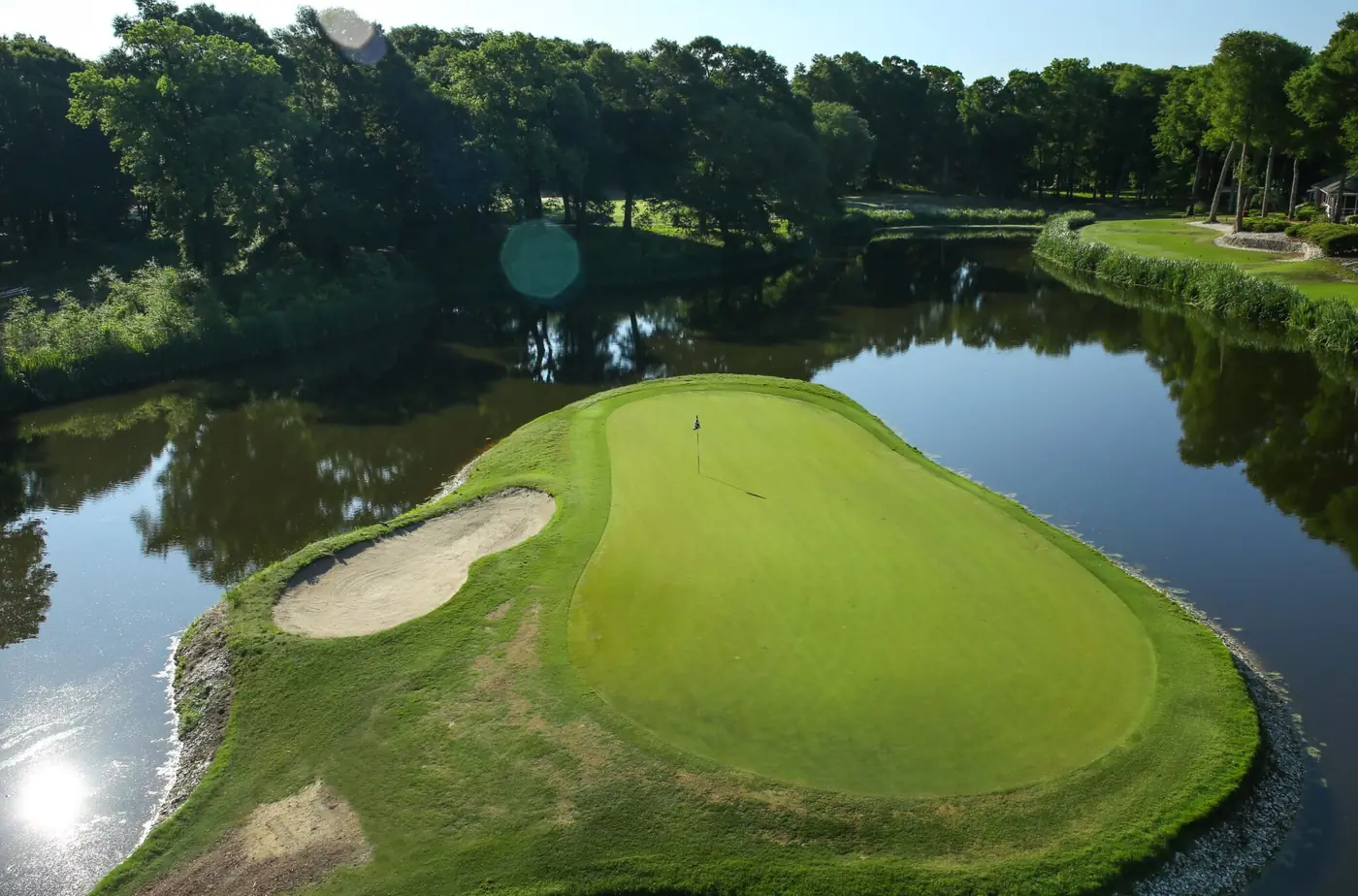 An island green surrounded by water at Oyster Bay Golf Links in Sunset Beach, North Carolina
